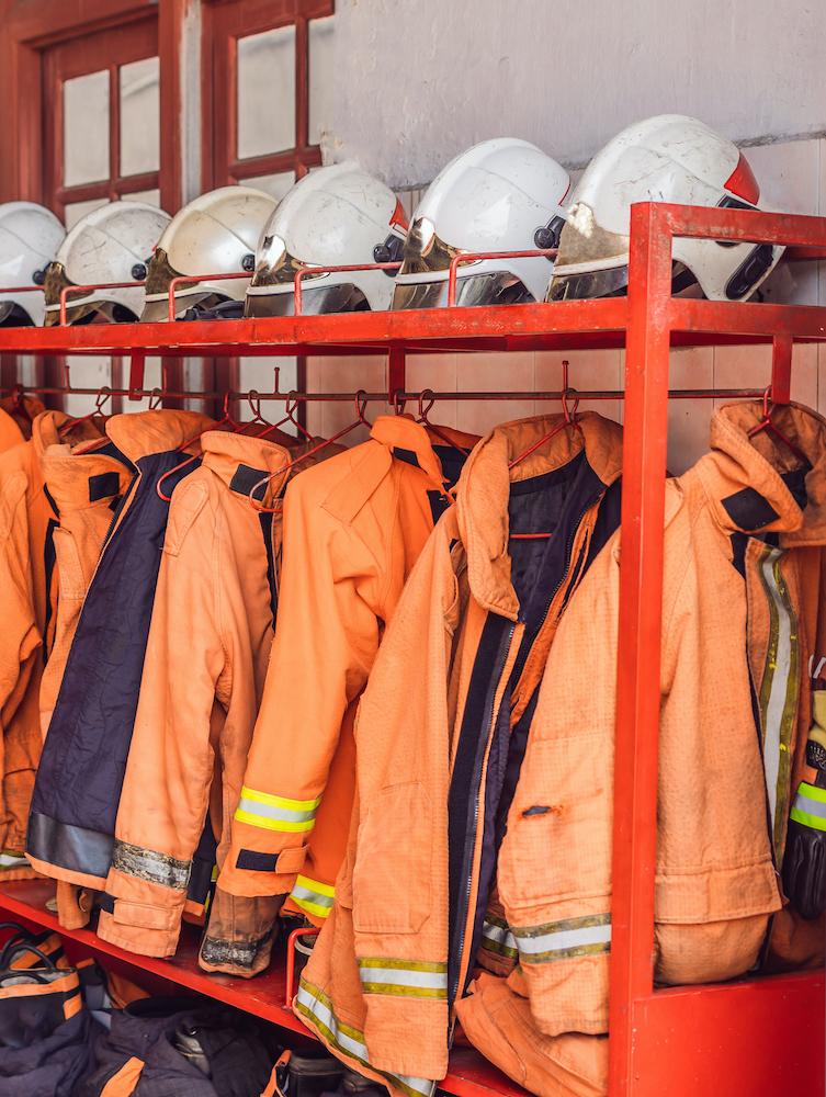 turnout coats and helmets in a line at a fire station